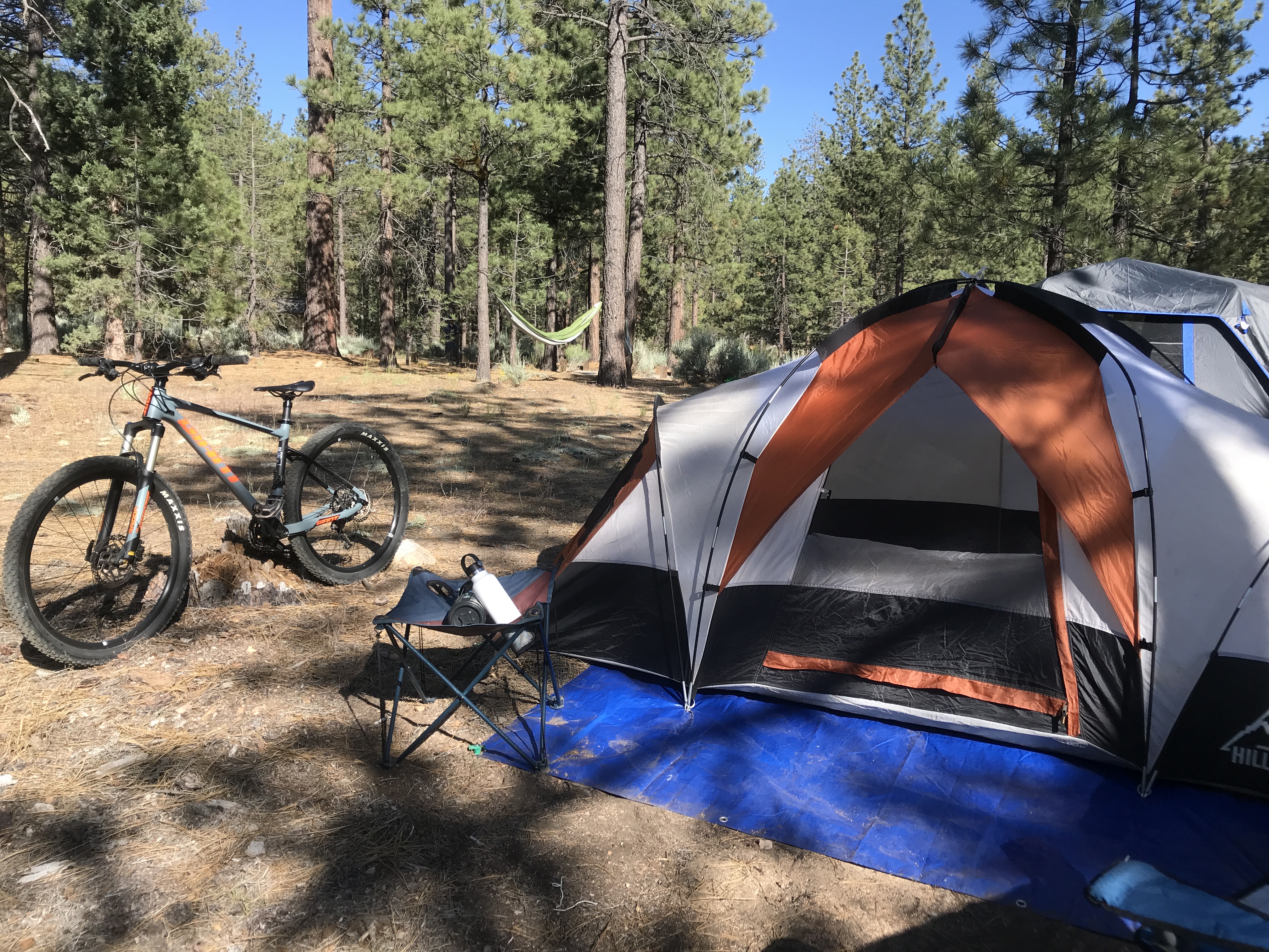 Man dressed in offroad moto gear posing with a dirtbike