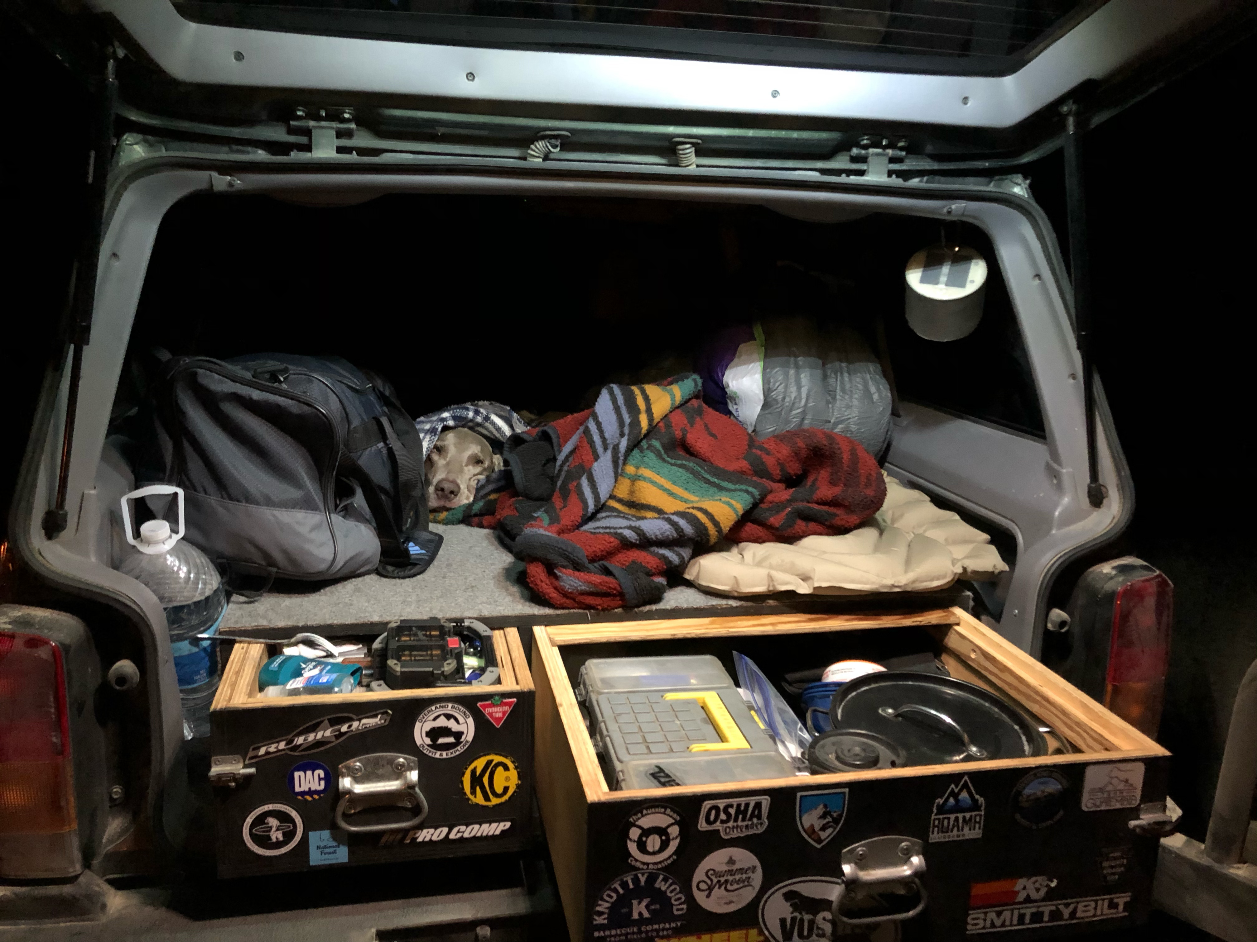 Blue Tacoma navigating a trail while wheels lift off the ground