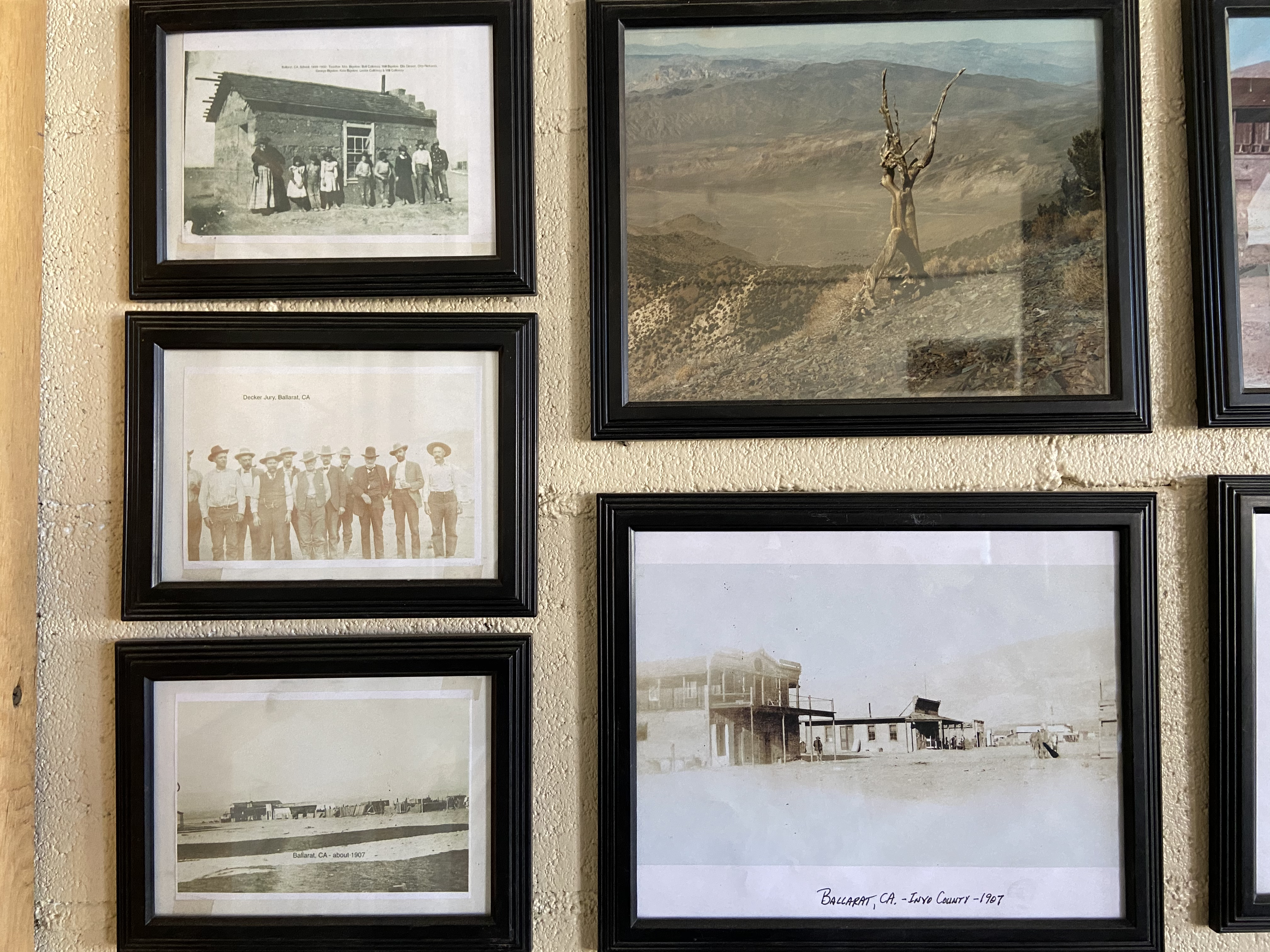 Flyers/photos/articles framed on a wall.