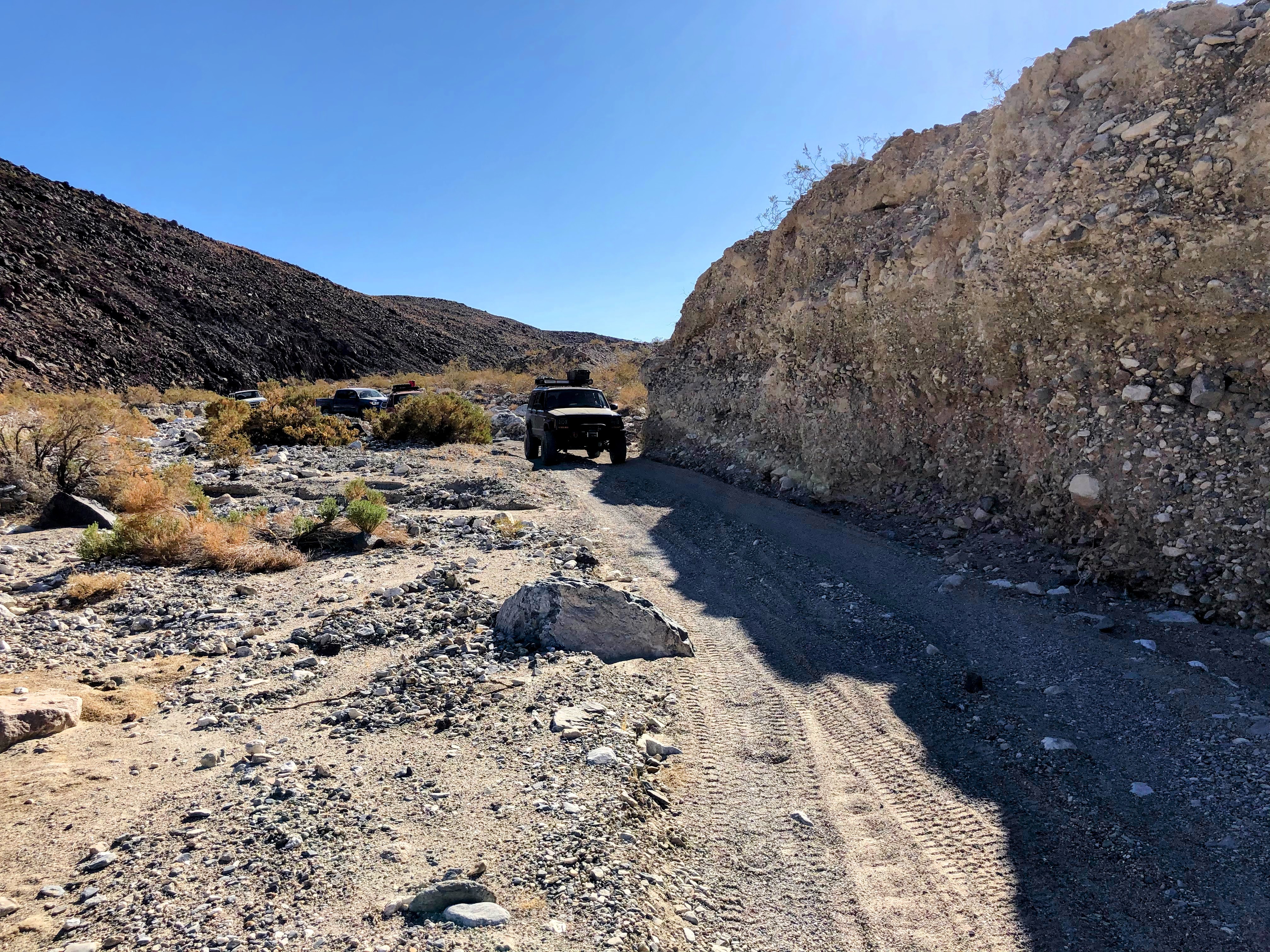 Green Jeep XJ on a dirt trail.